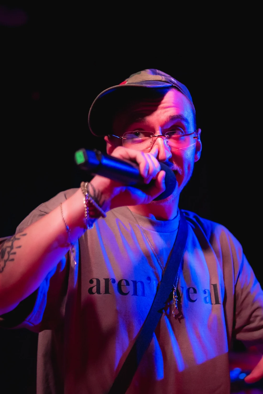 Dru Kelly performing under cobalt and red stage lights