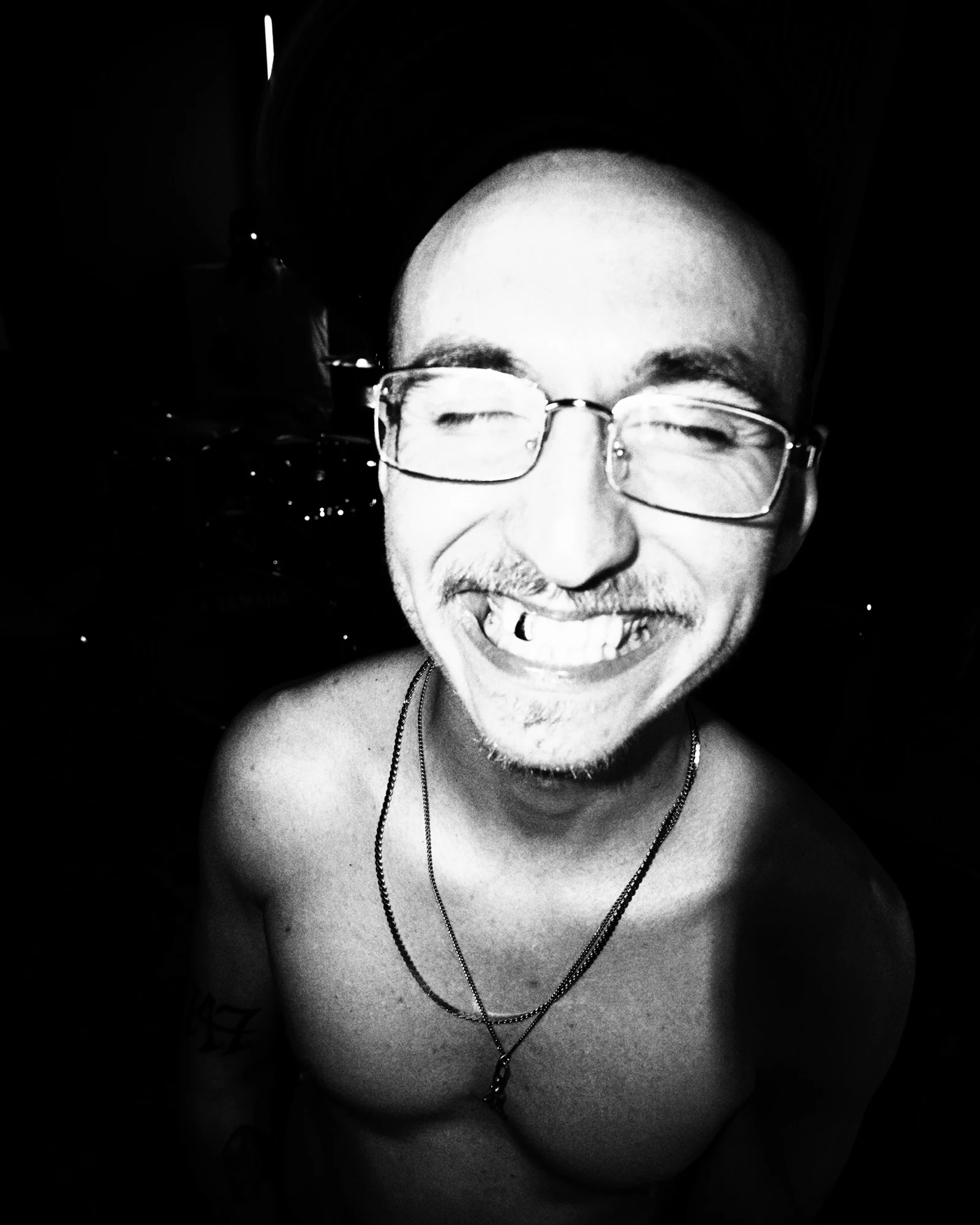 Black-and-white flash portrait of Dru Kelly smiling